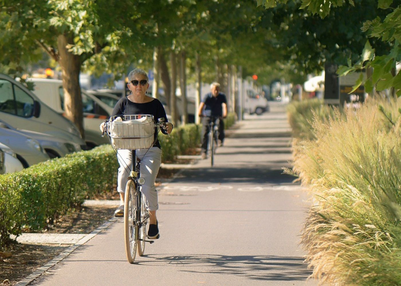 Two senior citizen riding a bicycle