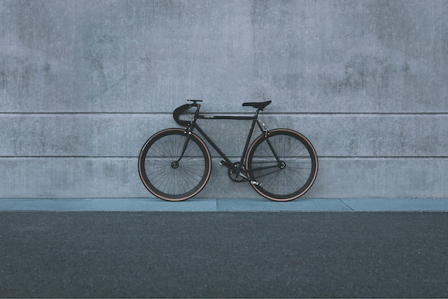 fixed hear bike resting on wall
