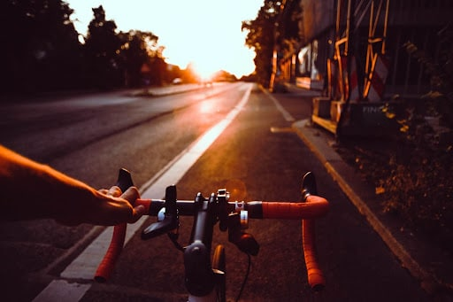 Sunset road point of view of a cyclist
