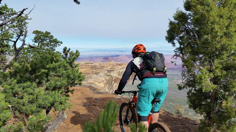 a cyclist riding up a mountain bike on a challenging route