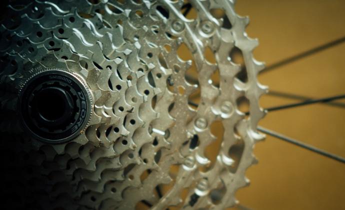 A detailed close-up photograph showcasing the intricate components of a mountain bike groupset.