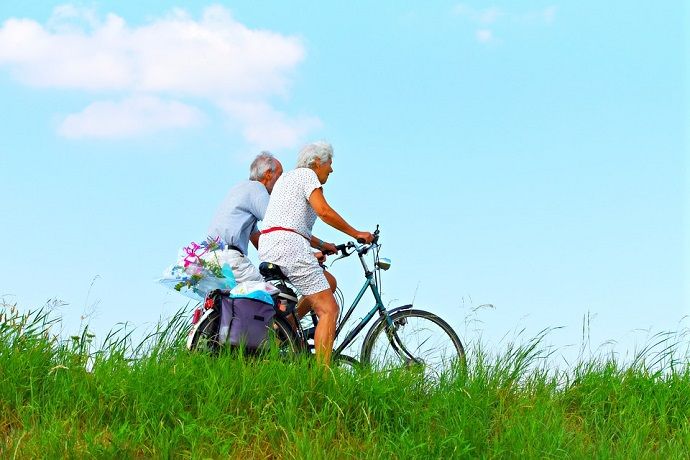 Elderly couple riding in a bicycle