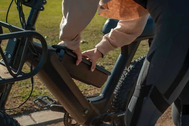cyclist inserting newly charged e-bike battery