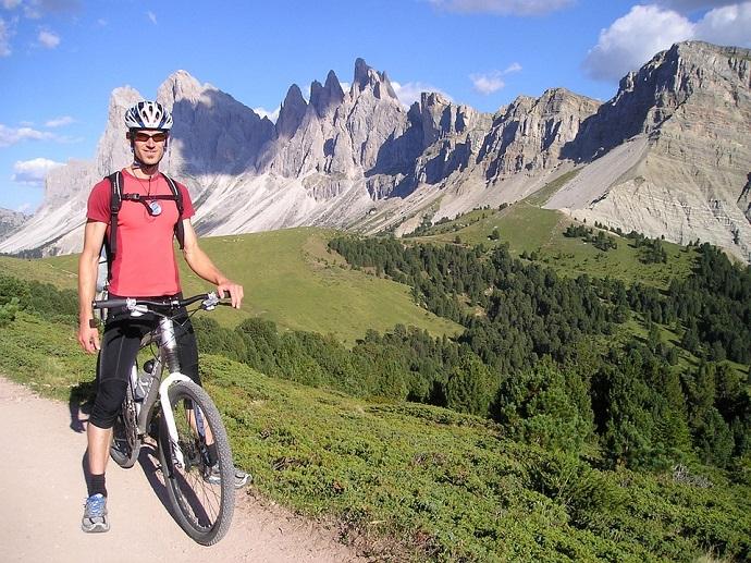 a person on a mountain bike with mountains in the background